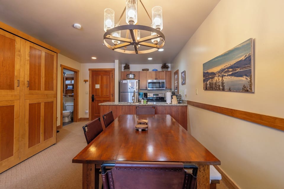 Murphy bed disappears into wall cabinet. Shows dining area, kitchen, and Bath 2 