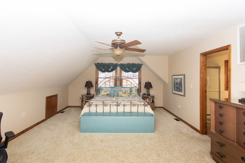 Master bedroom in loft with king size bed.