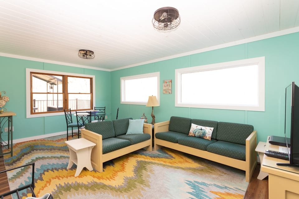 Second living room with additional seating. Monitor with DVD player and movies.