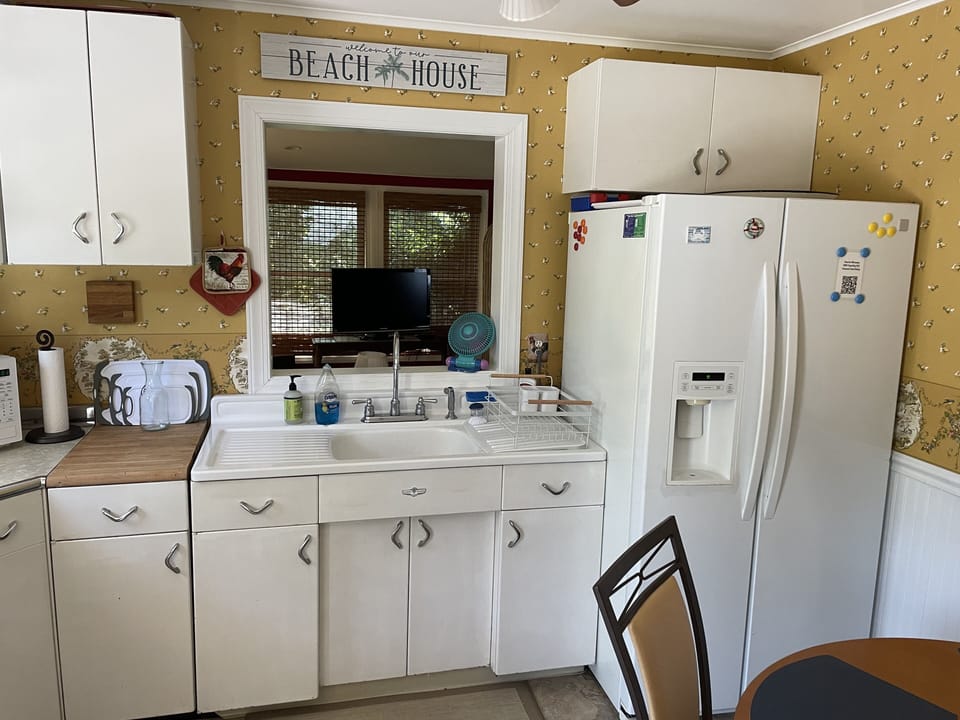 Kitchen with an open window to the sun room.