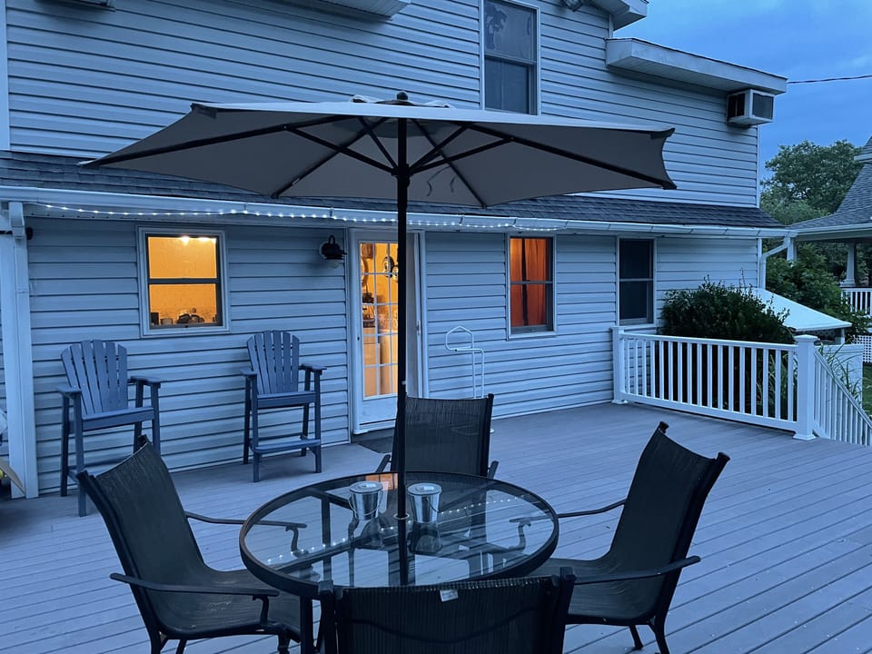 There are several umbrellas on the deck.