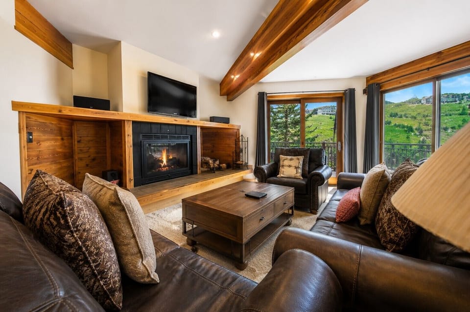 A comfortable, light-filled living room with mountain views right outside