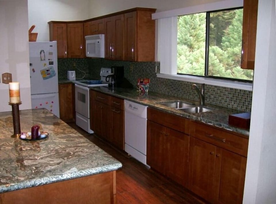 Full kitchen with maple cabinets and granite slab counters/island