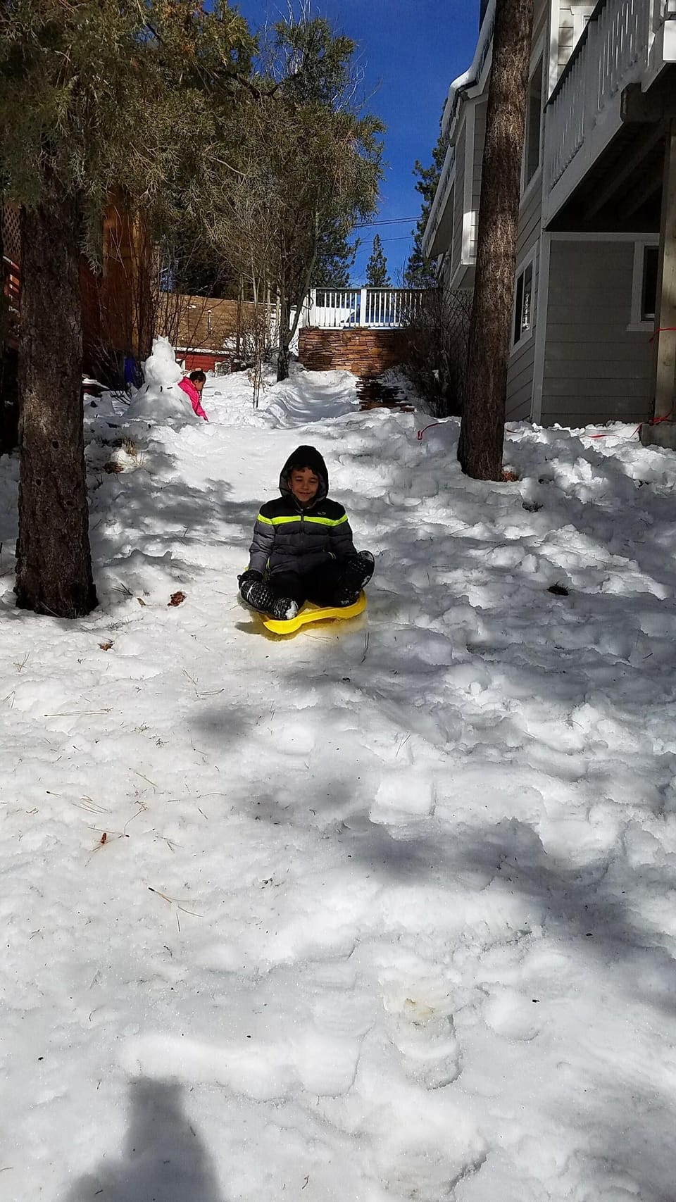 There is a sledding hill on the side of the house! (Winter View)