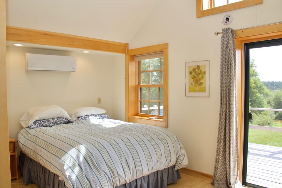 Queen sized bed window and sliding doors out the the deck.