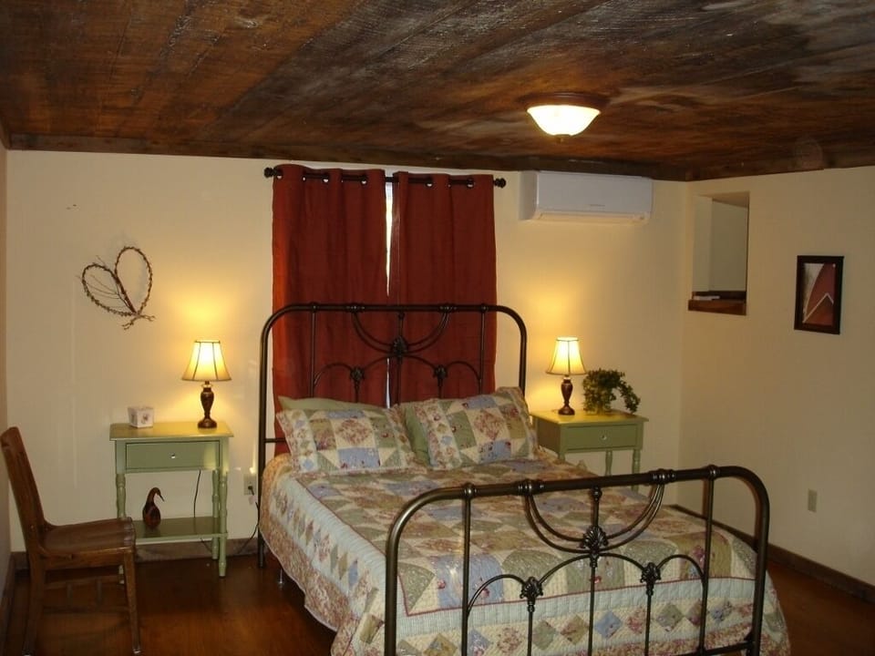 Queen-Sized Bed; Hand-Sawn Ceiling Boards from 1856 are a foot wide.