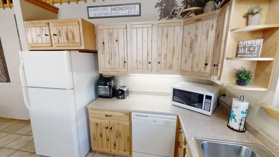 Your well-equipped kitchen features modern appliances and ample counter space for preparing meals, with charming rustic cabinetry and all the essentials you need for a comfortable stay.