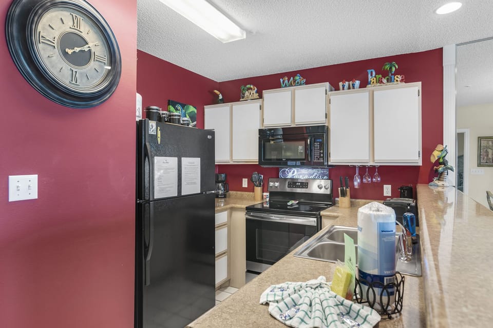 A cheerful kitchen with full appliances for cooking in.