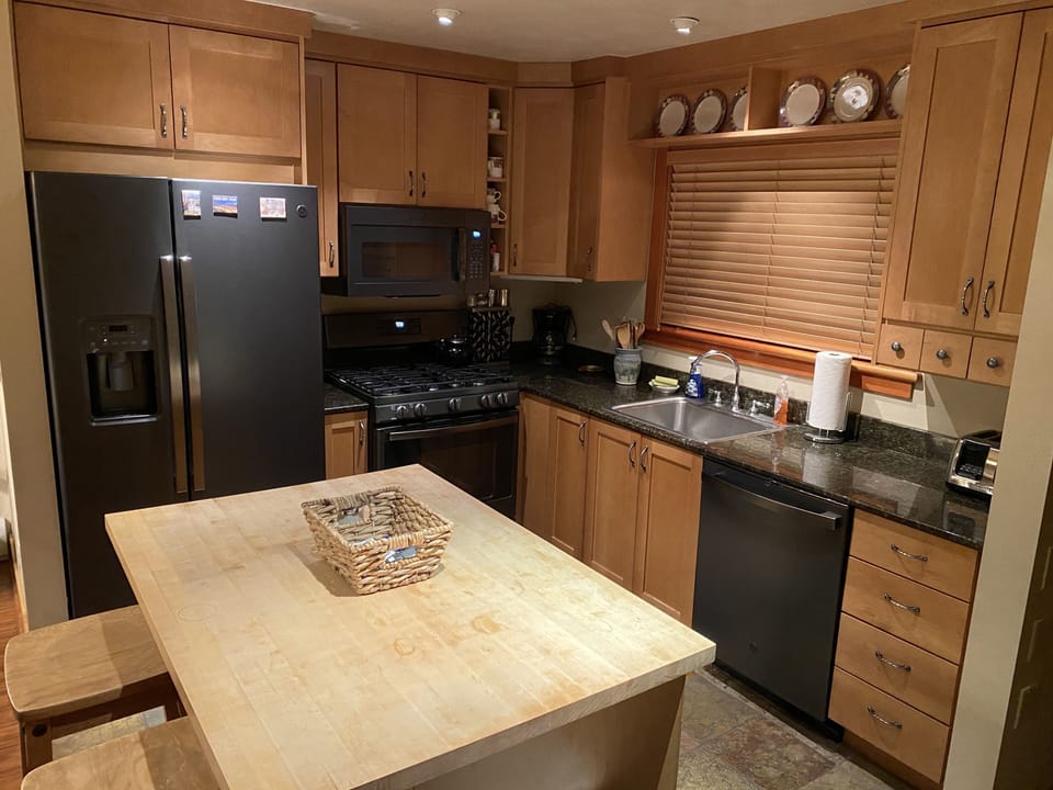 Kitchen with all black stainless steel appliances.