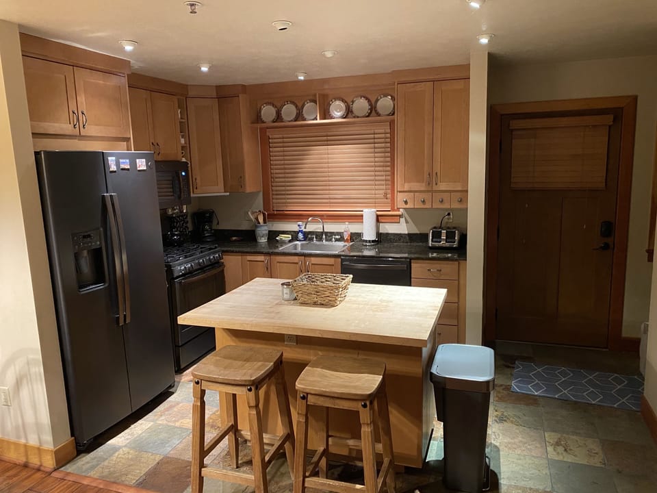 Kitchen with all black stainless steel appliances.