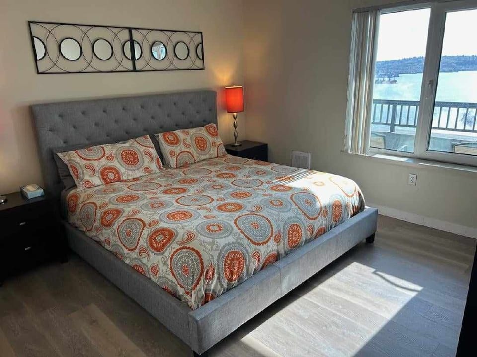 En suite bedroom with king bed and water views
