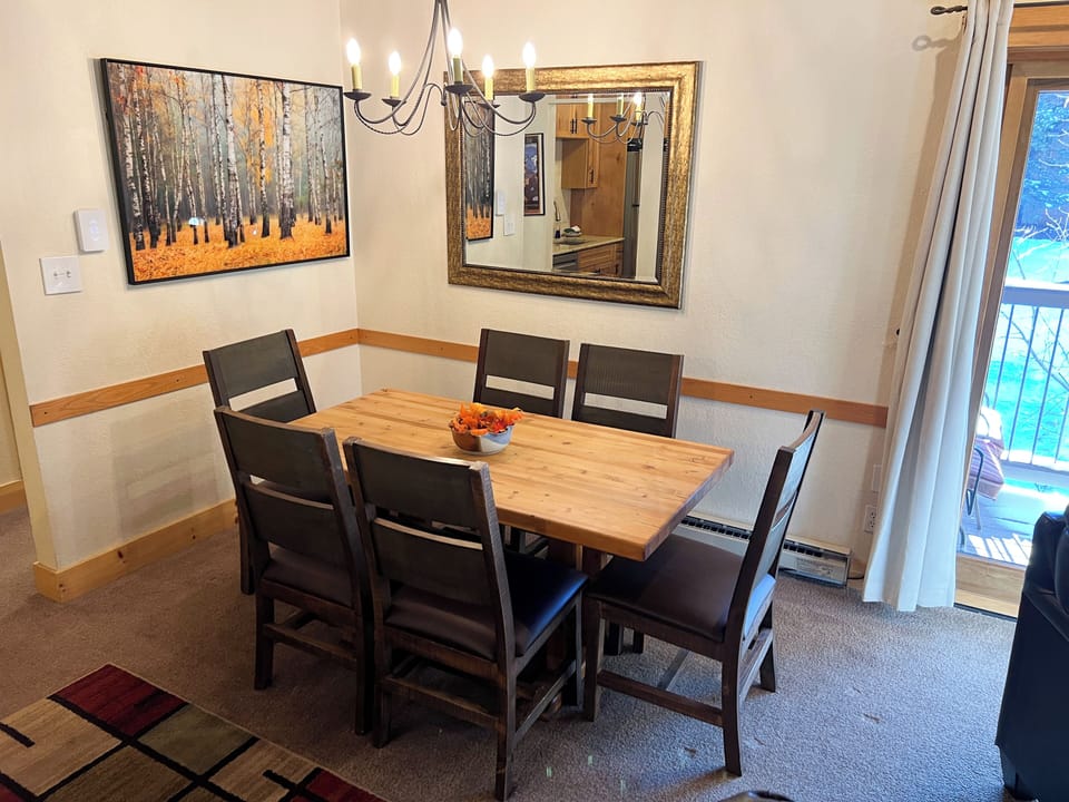 Dining room table seats 6 + 3 stools at the kitchen bar.