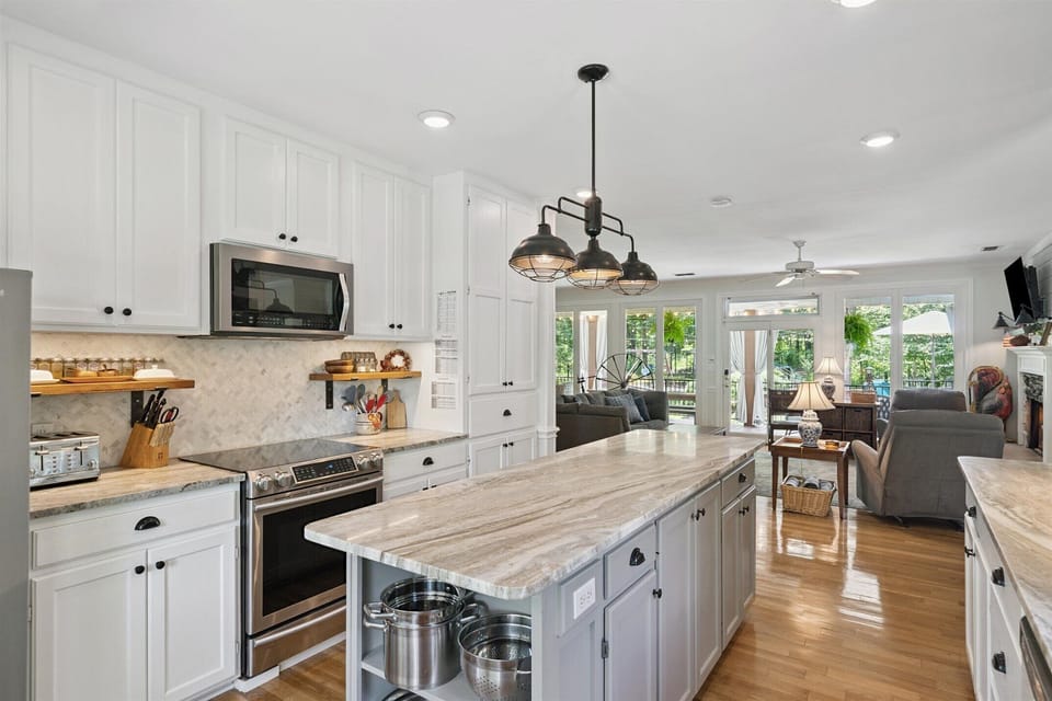 Large  fully equipped kitchen with 9 ft. island, induction range, serving space.