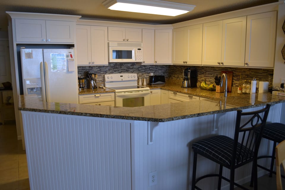 Fully stocked kitchen with granite countertops