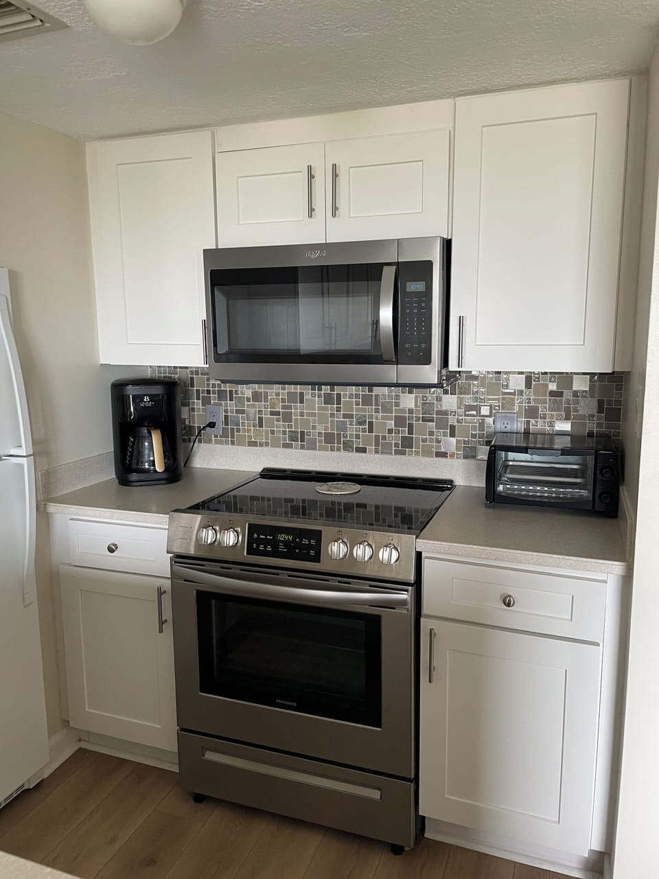 Brand new stainless steel stove/oven and microwave, drop coffee maker & toaster