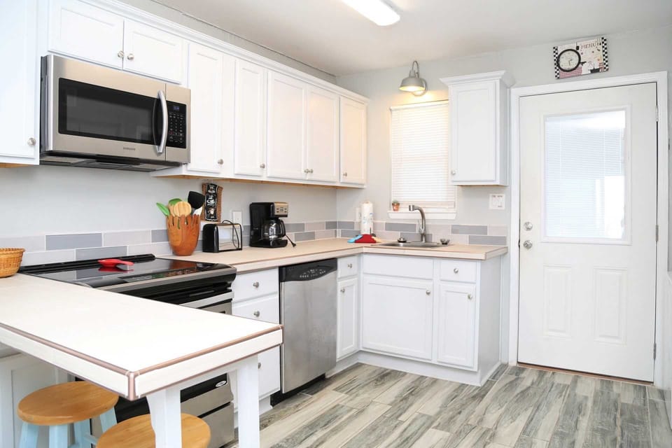 The kitchen includes new cabinets, upgraded appliances, & counter.