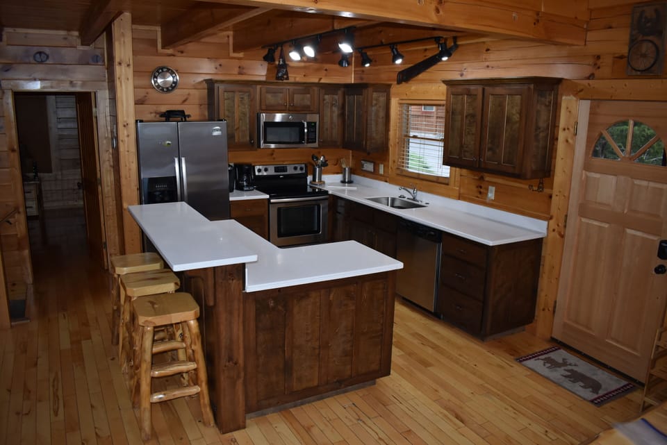 Kitchen w/ new counters, large sink, faucet, and disposal.