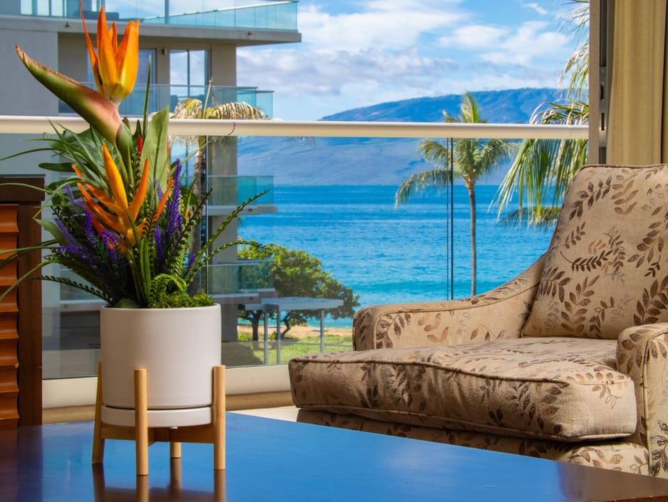 Bright and inviting decor with tropical accents complements the stunning ocean view from the living room.