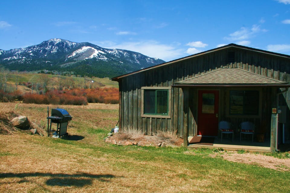 Cabin's front porch with BBQ grill.