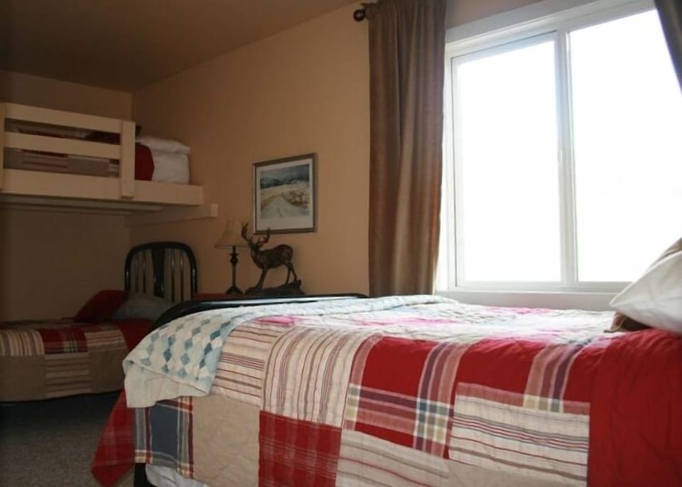 The fourth bedroom has a bunk bed, a double bed, and a bathroom down the hall.