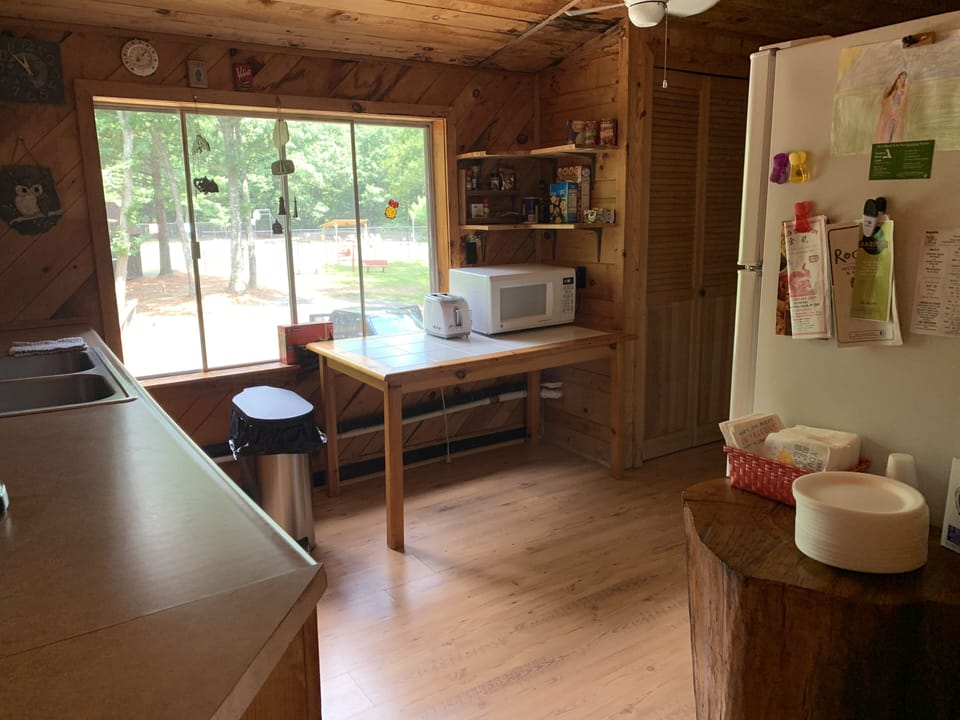 Kitchen has 2 fridges, stove, dishwasher, microwave, and attached laundry room.