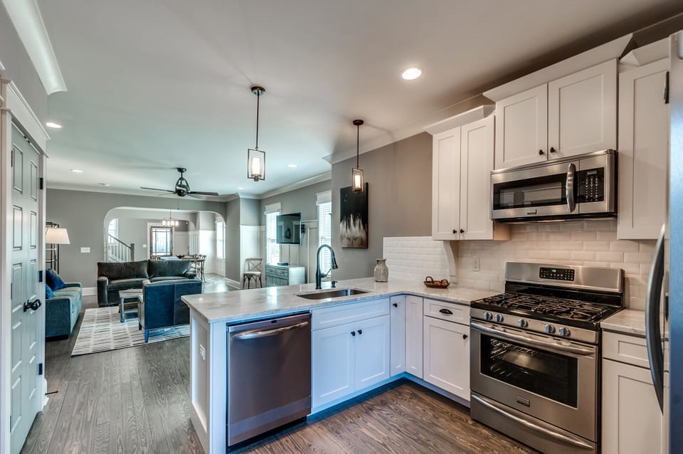 Open kitchen with microwave, dw, gas range/oven; lots of storage space, dishes