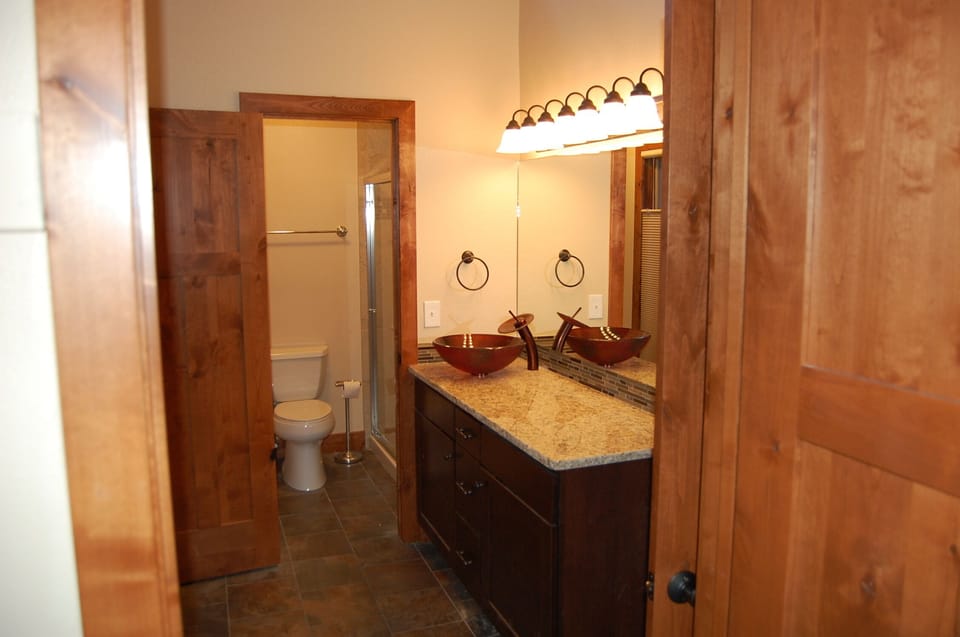Master bathroom with vessel sink, shower, and granite