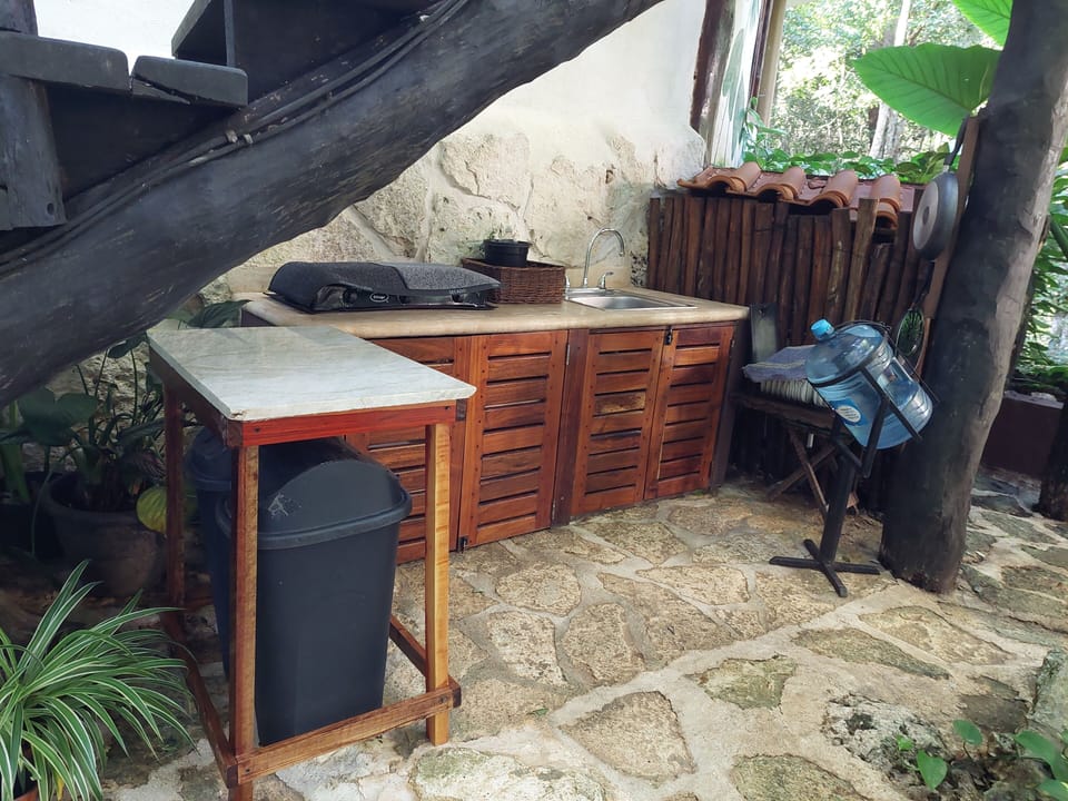 outdoor kitchen with gas stove, plates, silverware, pots, pans, coffee pot, etc.