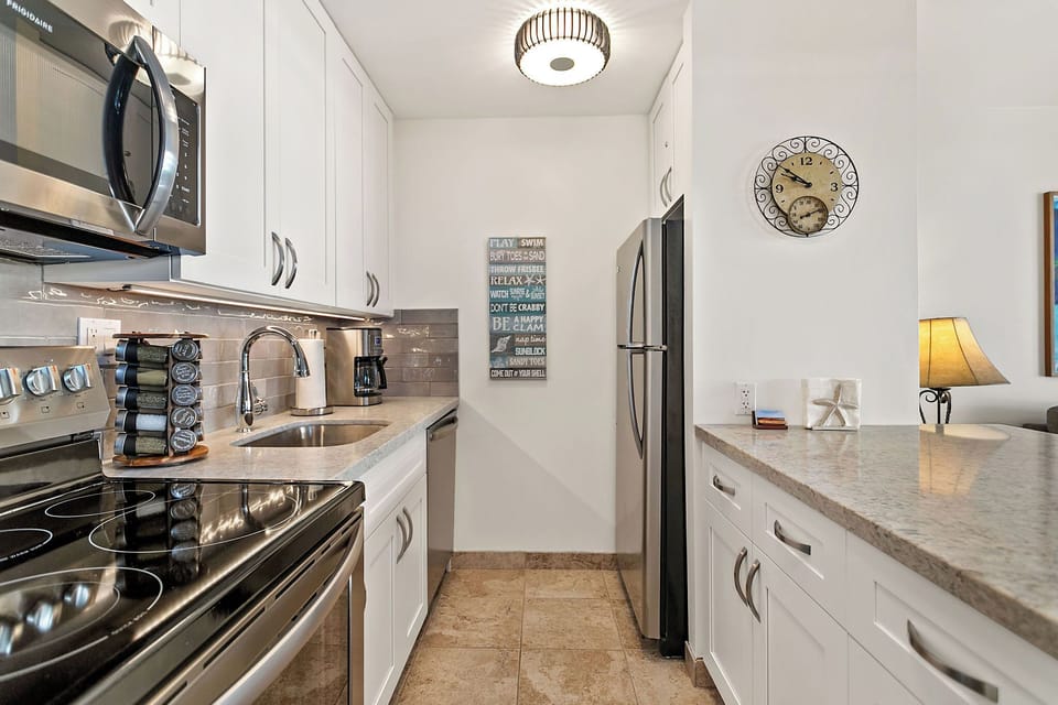 Modern kitchen with stainless steel appliances, Vitamix and spices