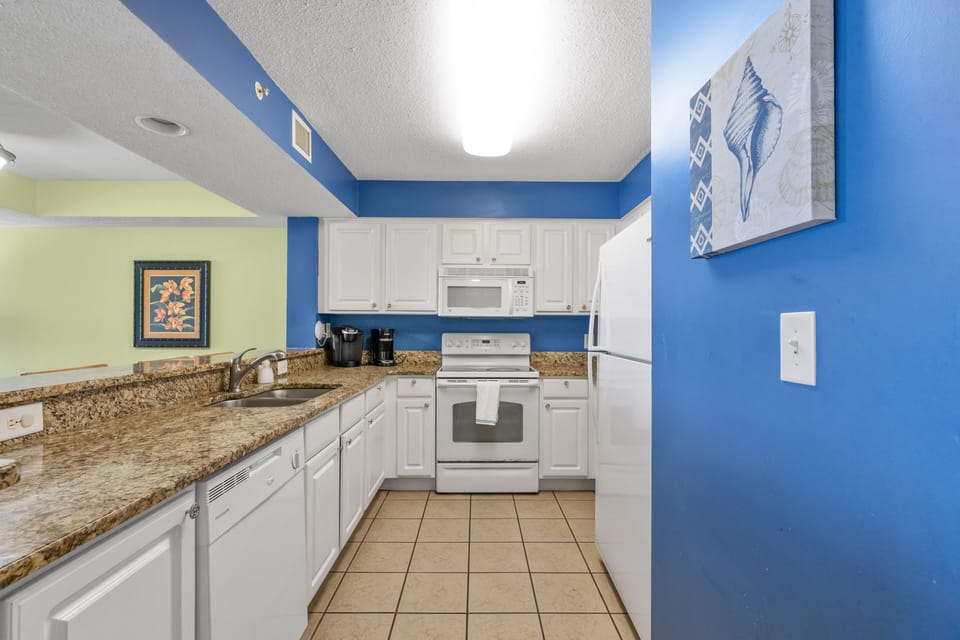 Large kitchen with granite counter tops, flat top stove and dishwasher