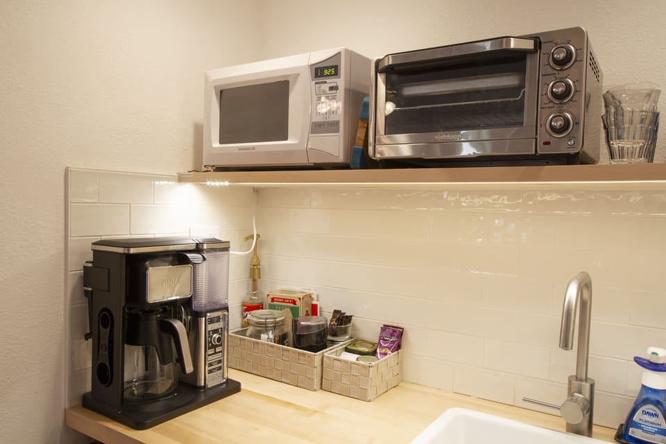 Coffee Maker, Toaster Oven, Microwave, snacks, coffee and teas provided.