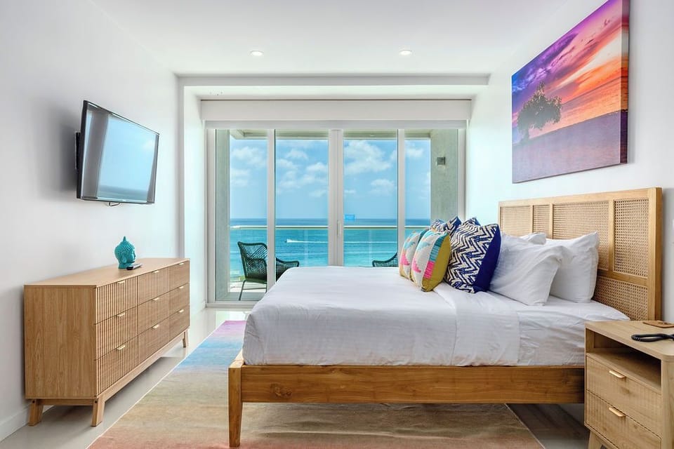 Wake up to breathtaking turquoise waters right from your bed. Drift off in crisp white linens while ocean breezes and natural light fill your bright, coastal-inspired bedroom retreat.