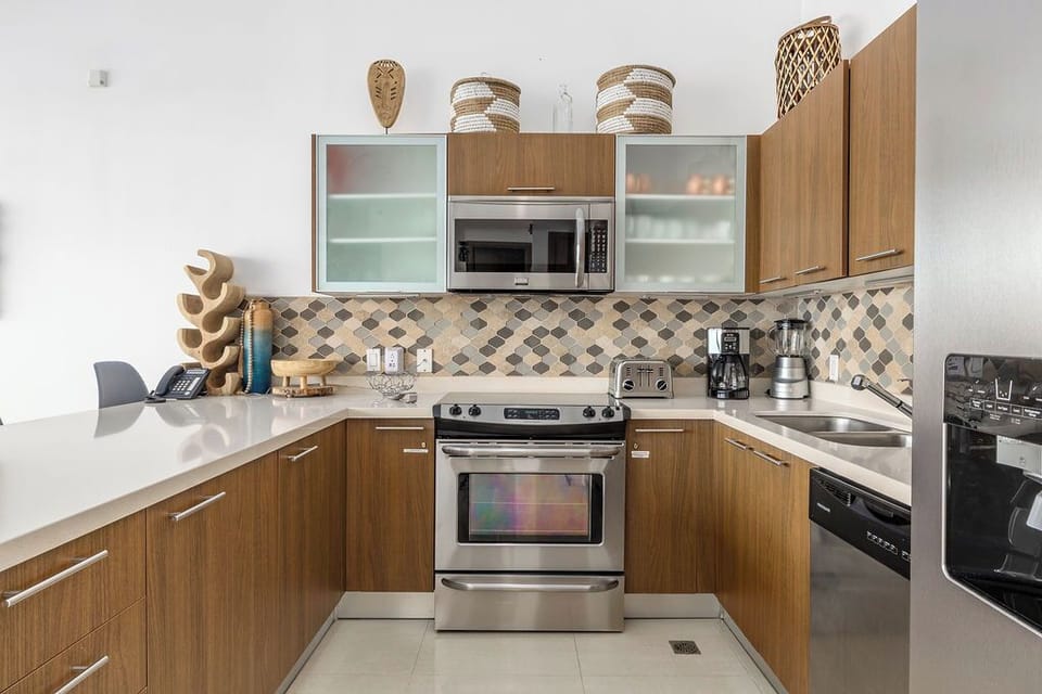 Your well-equipped kitchen offers sleek stainless-steel appliances and modern cabinetry, inviting you to prepare meals with ease in this stylish, functional space.