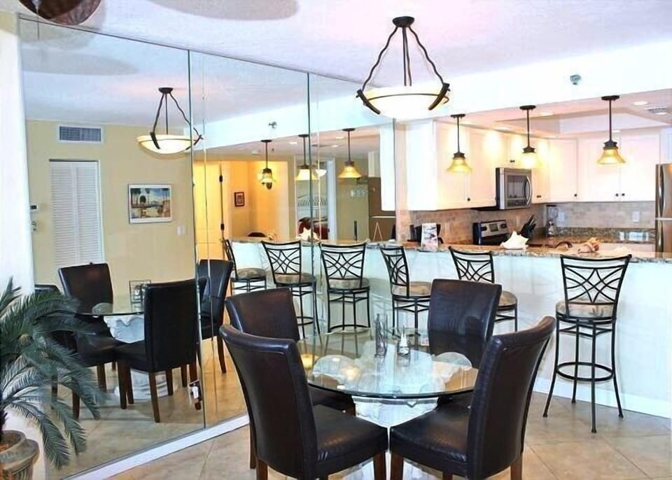 Dining table with 4 leather chairs, plus 3 more chairs at the breakfast bar!