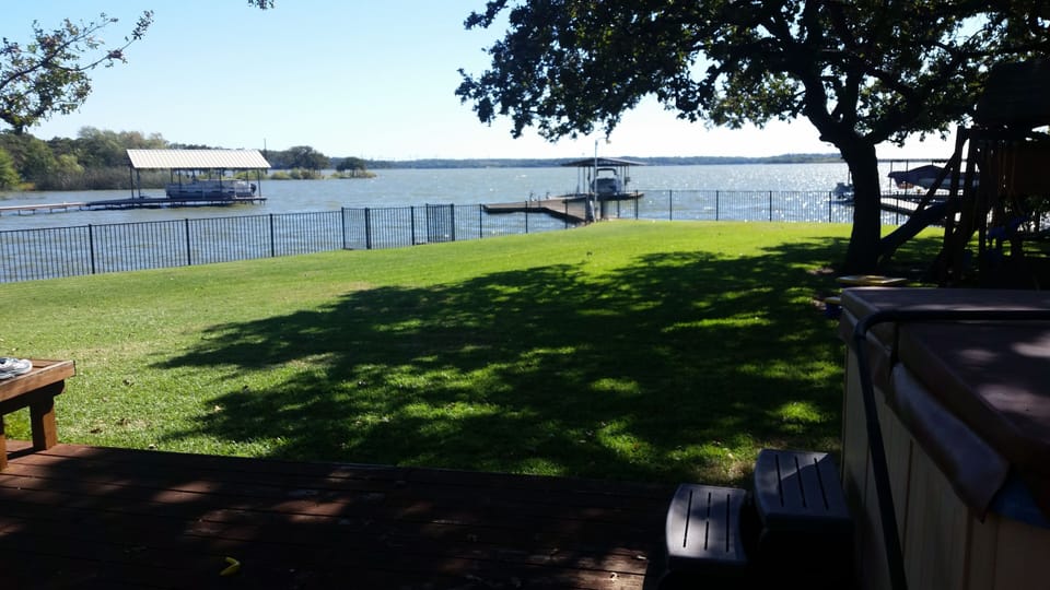 Large backyard with dock and lake swimming area.