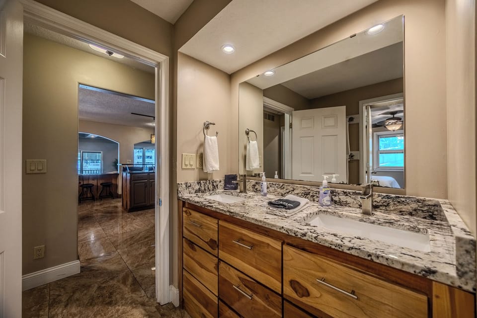 "Elegant bathroom with granite countertop and a dual-sink vanity design."