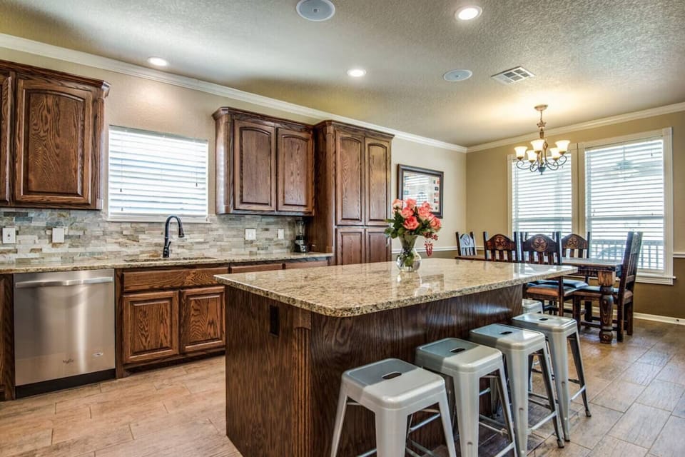 Another view of the private kitchen and a dining table at the far end.