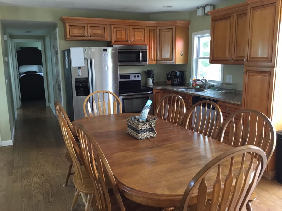 Dining and Kitchen with open floor plan, large pantry next to fridge in hallway
