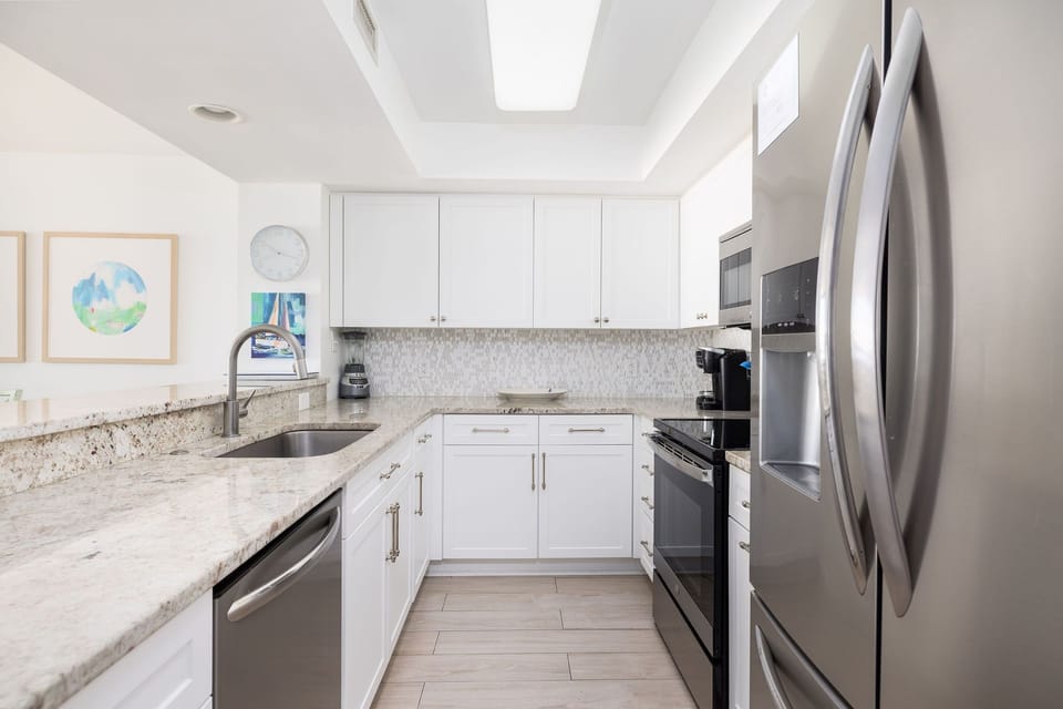 Fully equipped kitchen with sleek appliances, ample counter space, and everything needed for a beachfront stay.