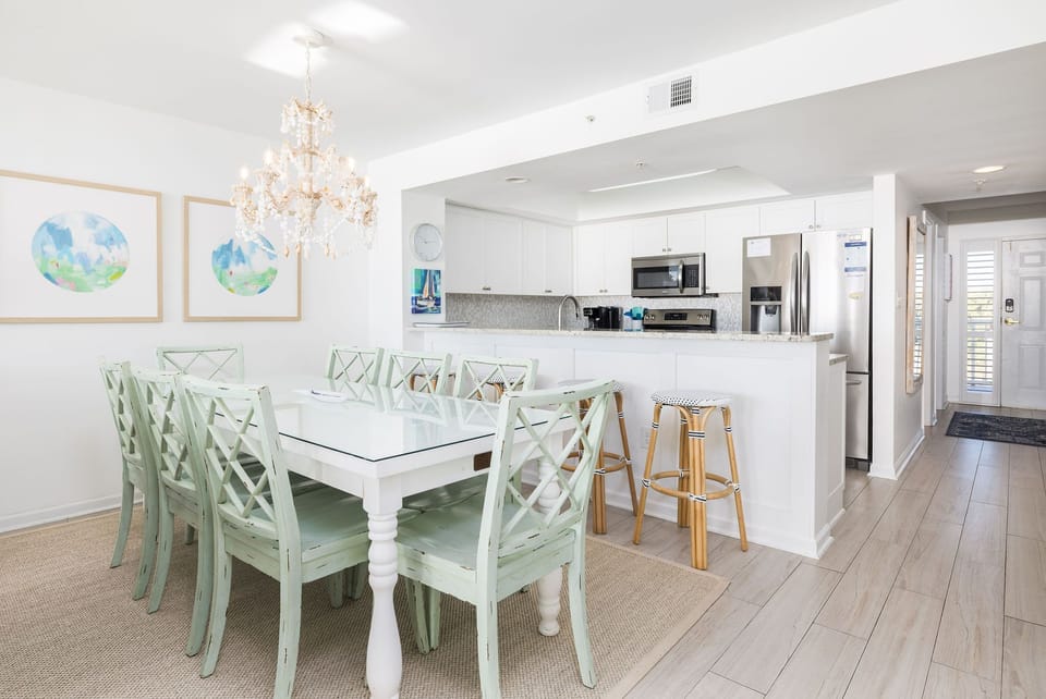 White cabinetry, modern lighting, and a welcoming open layout designed for entertaining