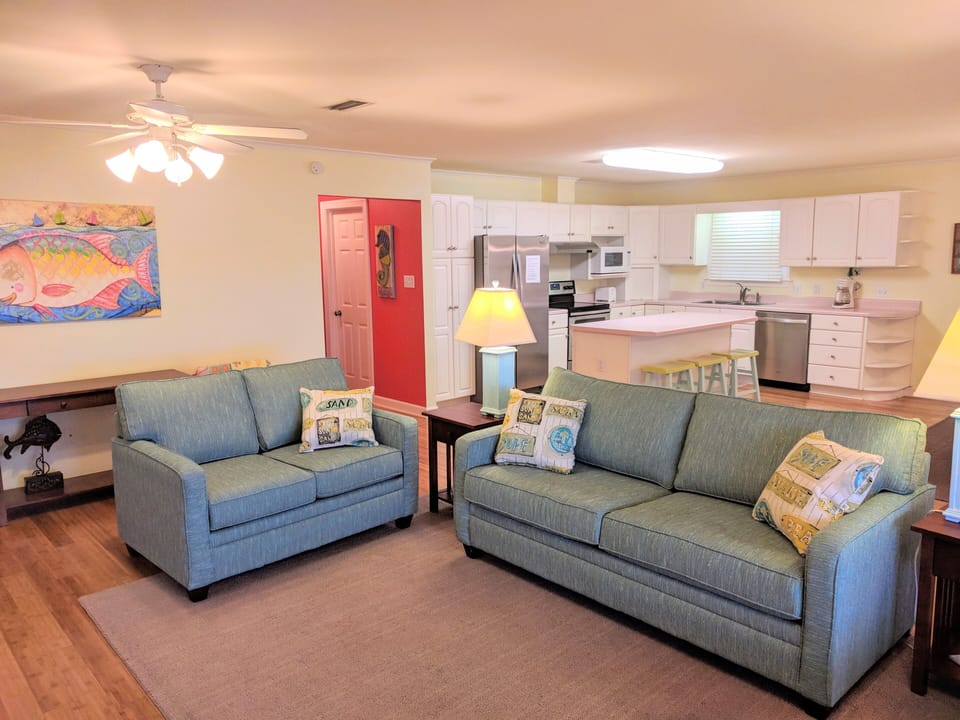 Large open great room, perfect for entertaining, with comfy sofas and TV