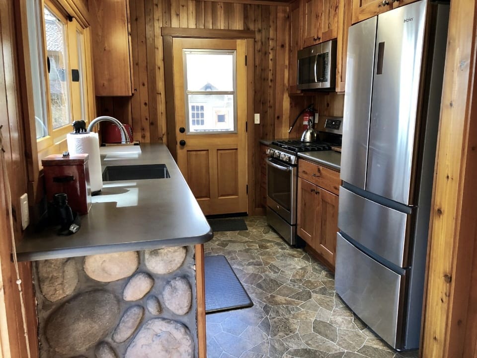 new kitchen with door directly to deck and hot tub