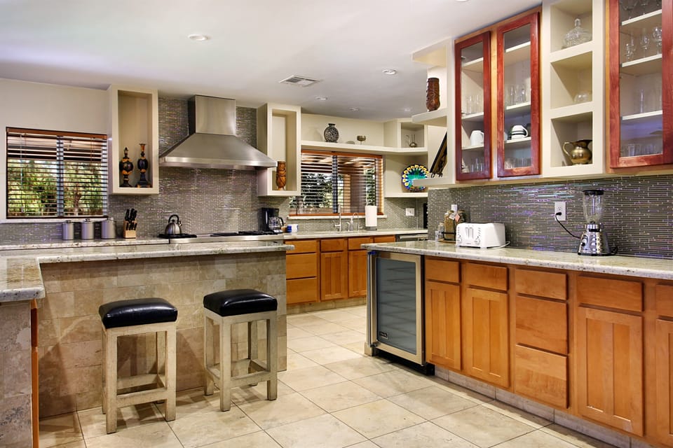 Fully equipped kitchen with granite counters, island seating, and a Viking beverage fridge. Room for the whole group to cook together.