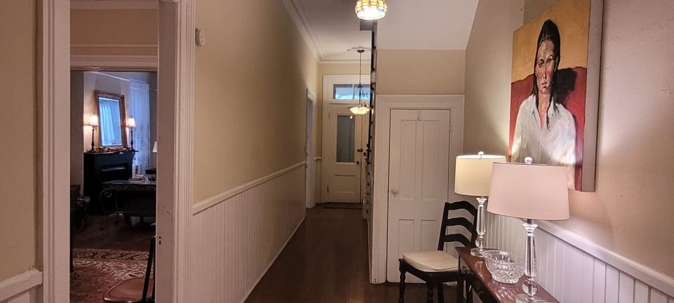 Central hallway in home with original artwork from local artist