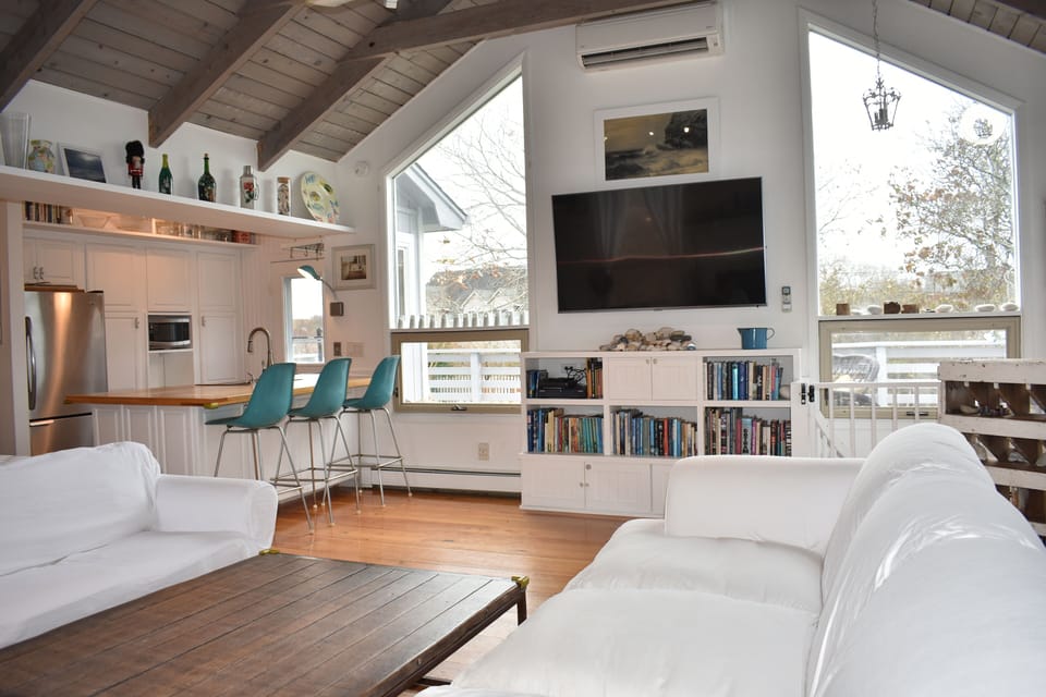 Vaulted living room south view; huge windows, great light and 65" flat screen.