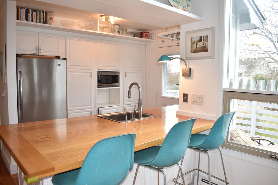Open kitchen has large countertop with bar seating