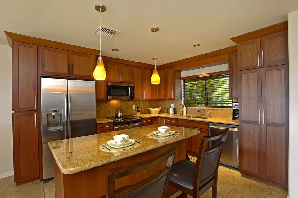 Kitchen with granite counter tops, stainless steel appliances, cherry cabinets