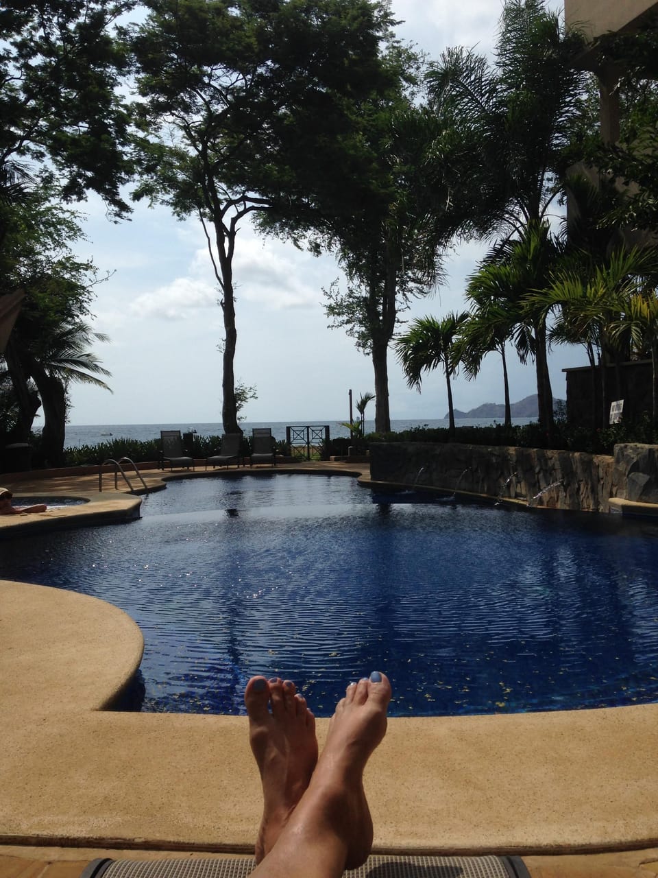 Relaxing at the pool, with the beach just beyond the gate!