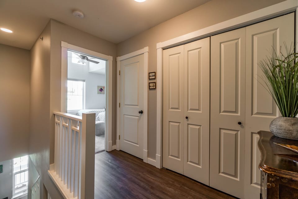 Upstairs landing with linen closet and storage.