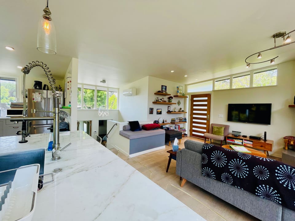 Living room, entryway, and stairwell from kitchen island